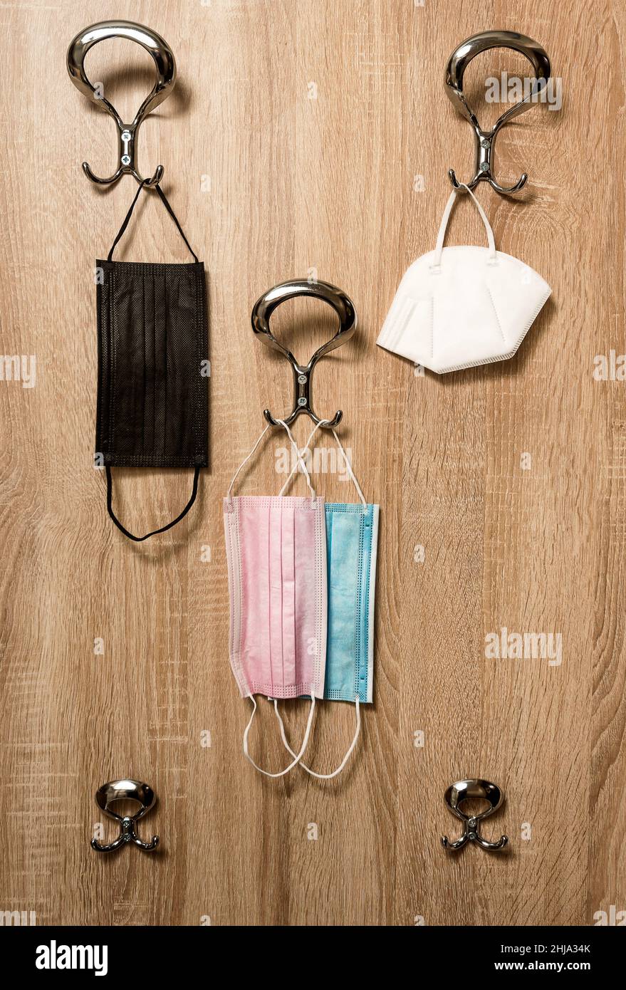 Protective surgical face masks on anteroom coat hanger stand during covid-19 pandemics Stock Photo