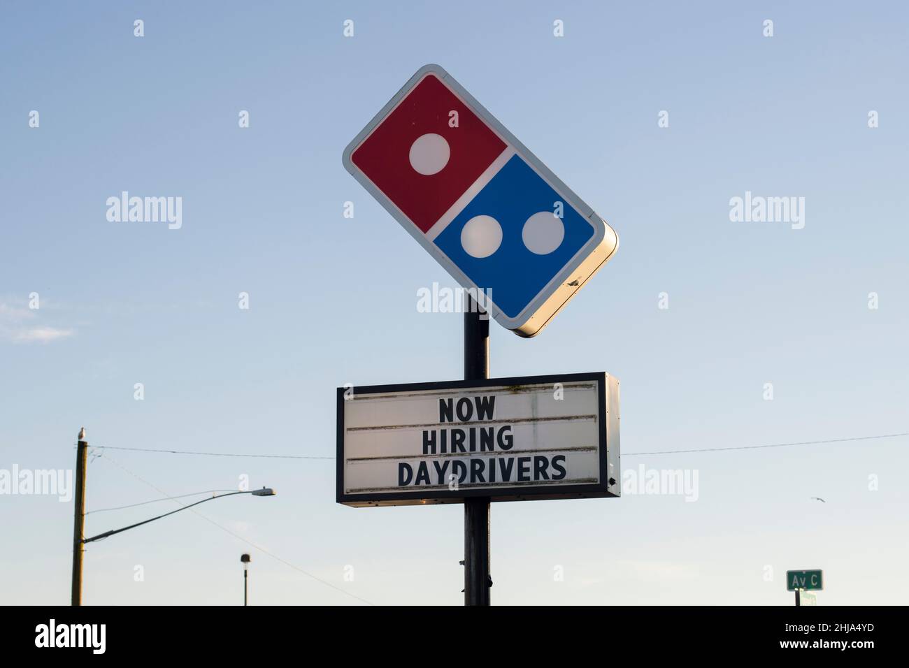 Domino's sign with hiring ads is seen outside one of its locations in Seaside on the Oregon Coast on Saturday, January 22, 2022, amid a nationwide... Stock Photo