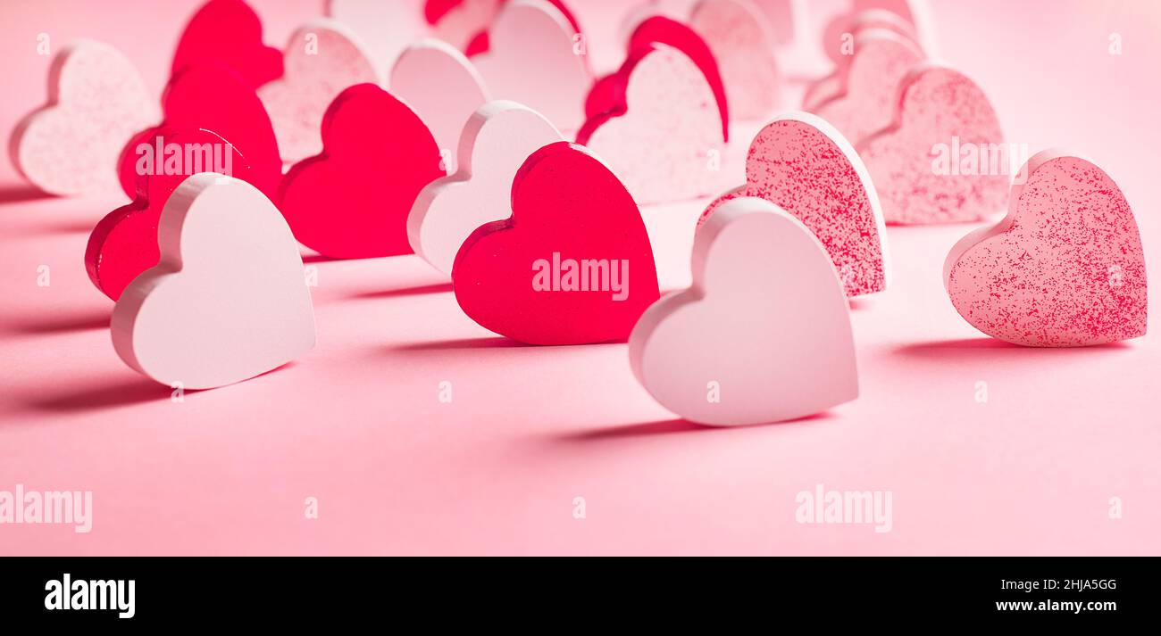 Lots of pink and white hearts on a light pink background. Love concept.  Greeting  of different colored wooden  s day  Stock Photo - Alamy