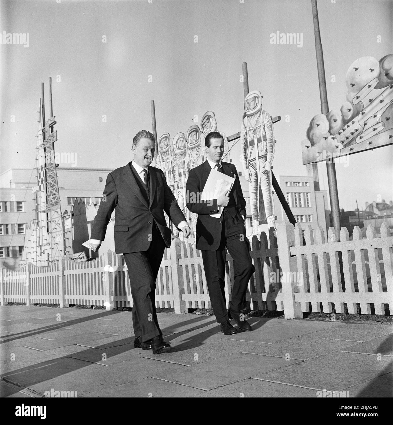 The Conservative Party Conference in Blackpool. Quintin Hogg, Lord Hailsham, takes a stroll along the front with his ex-personal secretary Dennis Walters, a delegate for Wiltshire East after an afternoon of top level discussions. They walk past Russian Spacemen - an illuminations setpiece. 11th October 1963. Stock Photo