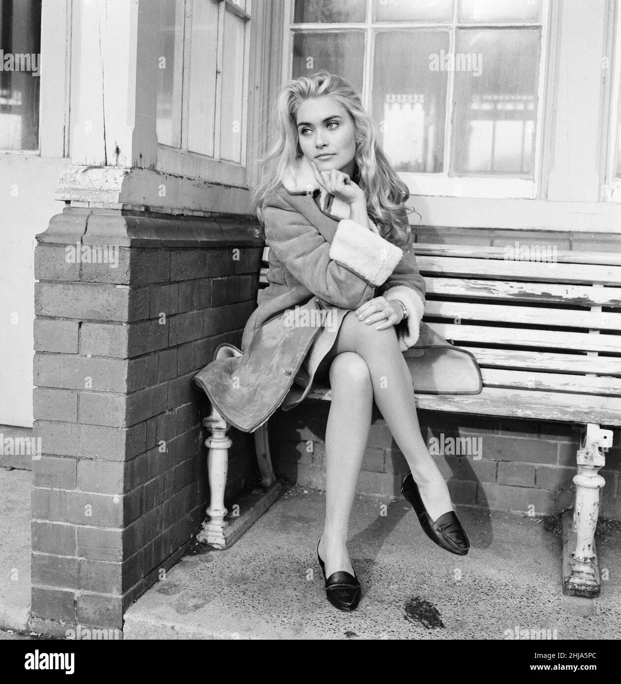 Alexandra Bastedo, 18 years old actress from Hove, Sussex, Friday 18th December 1964. Alex has recently appeared in The Count of Monte Cristo, television series as character Renée de Saint-Méran.  Pictured posing for pictures, while sitting in a bus shelter in Hove. Stock Photo