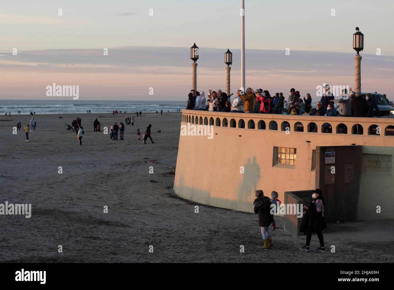 Visitors to the beach in Seaside, Oregon, during sunset on Saturday, January 22, 2022, amid the pandemic. Oregon still has not hit the omicron peak... Stock Photo
