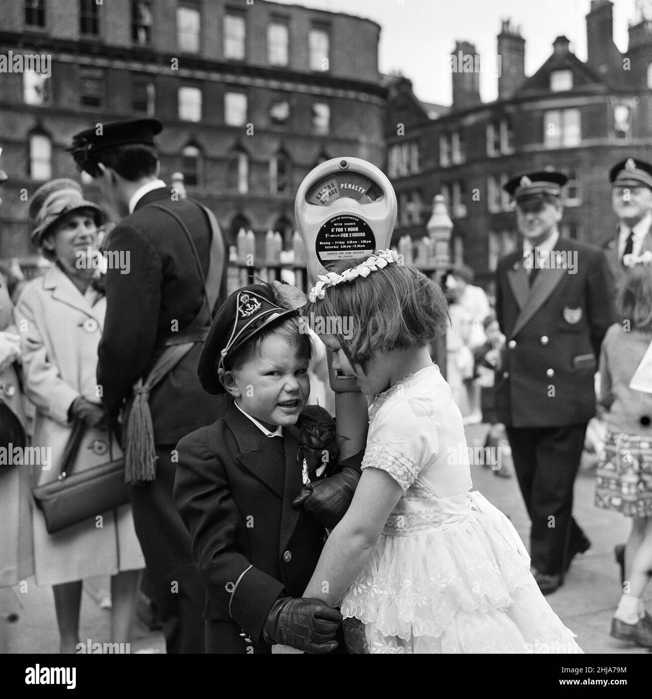 Whit Monday walks in Collyhurst, Manchester.  A demonstration of affection between Terrance Coltan, aged 7, and Deidre Cairns, aged 7, walking with St Oswalds. 3rd June 1963. Stock Photo