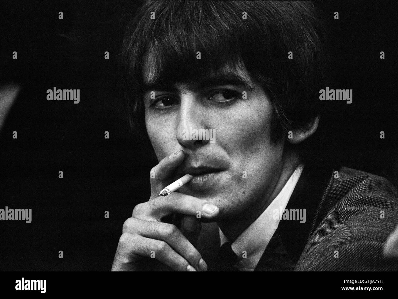 The Beatles Summer 1964 Tour of the United States and Canada.The band flew out from Heathrow Airport for San Francisco International on the 18th August, briefly stopping at Los Angeles airport en route. Pictured is Beatles guitarist George Harrison smoking a cigarette during a press conference in Atlantic City, New Jersey. 30th August 1964.       GH2001 Stock Photo
