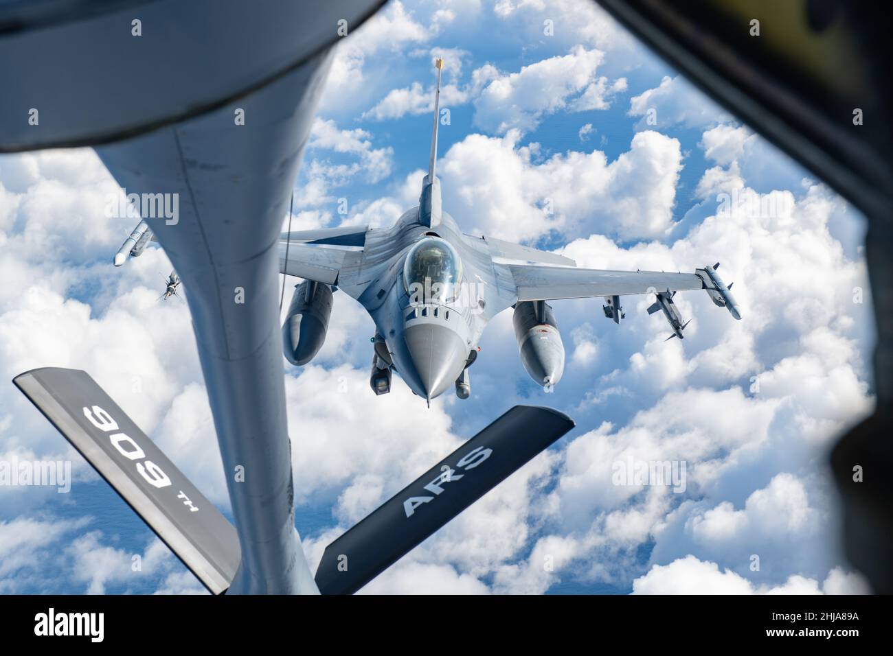 A U.S. Air Force F-16 Fighting Falcon assigned to the 14th Fighter Squadron at Misawa Air Base approaches a 909th Air Refueling Squadron KC-135 Stratotanker to receive fuel during Exercise PACIFIC WEASEL (PAC WEASEL) over the Pacific Ocean Jan. 21, 2022. The goal of PAC WEASEL is to enhance the defensive capabilities of U.S. Forces Japan and Japanese allies. The 909th ARS refueled fighter jets during the exercise, supporting the U.S.’ commitment to defending a free and open Indo-Pacific region. (U.S. Air Force photo by Airman 1st Class Cesar J. Navarro) Stock Photo