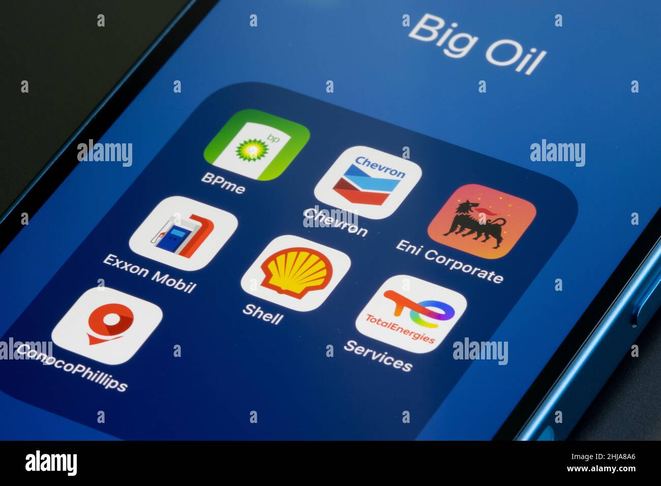 App icons representing Big Oil (supermajors) - BP, Chevron, Eni, ExxonMobil, Royal Dutch Shell, TotalEnergies, ConocoPhillips - are seen on an iPhone. Stock Photo