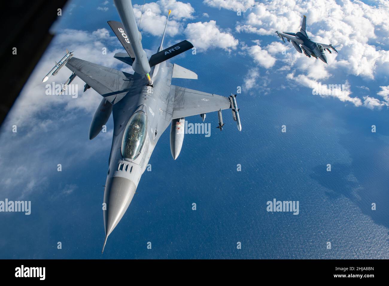 Two U.S. Air Force F-16 Fighting Falcons assigned to the 14th Fighter Squadron at Misawa Air Base take turns receiving fuel from a 909th Air Refueling Squadron KC-135 Stratotanker during Exercise PACIFIC WEASEL (PAC WEASEL) over the Pacific Ocean Jan. 21, 2022. The goal of PAC WEASEL is to enhance the defensive capabilities of U.S. Forces Japan and Japanese allies. The 909th ARS refueled fighter jets during the exercise, supporting the U.S.’s commitment to defending a free and open Indo-Pacific region. (U.S. Air Force photo by Airman 1st Class Cesar J. Navarro) Stock Photo