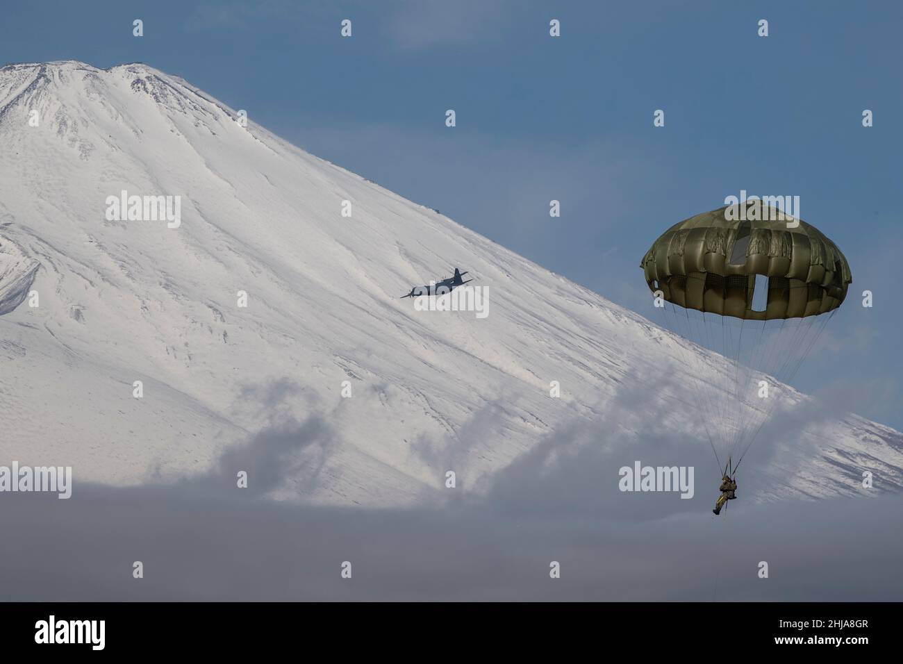 A Japan Ground Self Defense Force paratrooper prepares to hook his  parachute to a static line aboard a C-130J Super Hercules assigned to the  36th Airlift Squadron during an Airborne 21 exercise