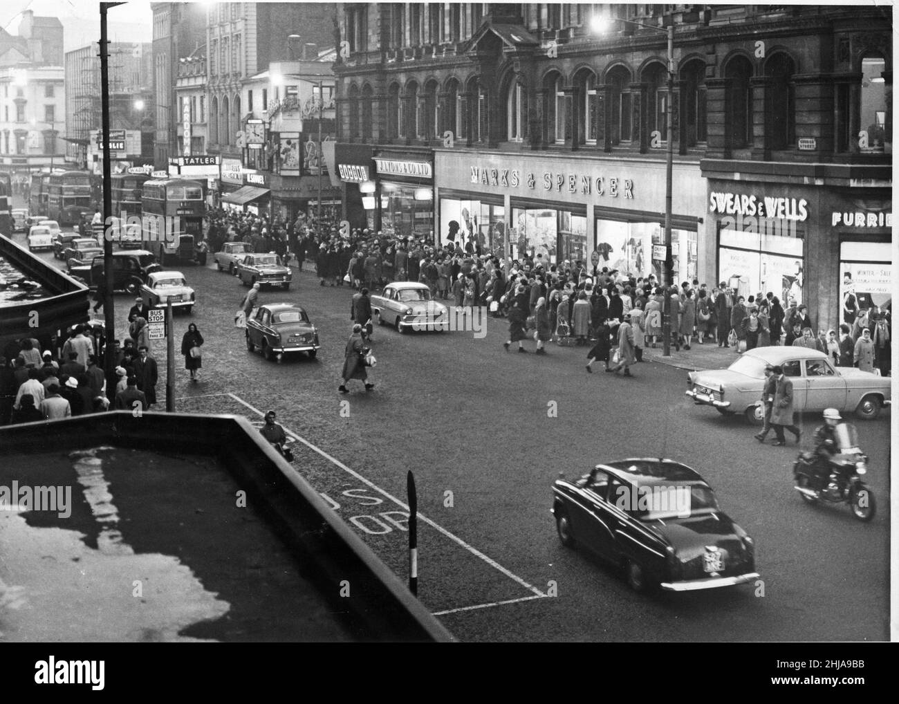 Shopping, cars and buses in a busy Church Street, Liverpool, England.  It is mid afternoon as shoppers hunt down a January Sale bargain. Picture taken 6th January 1962 Stock Photo