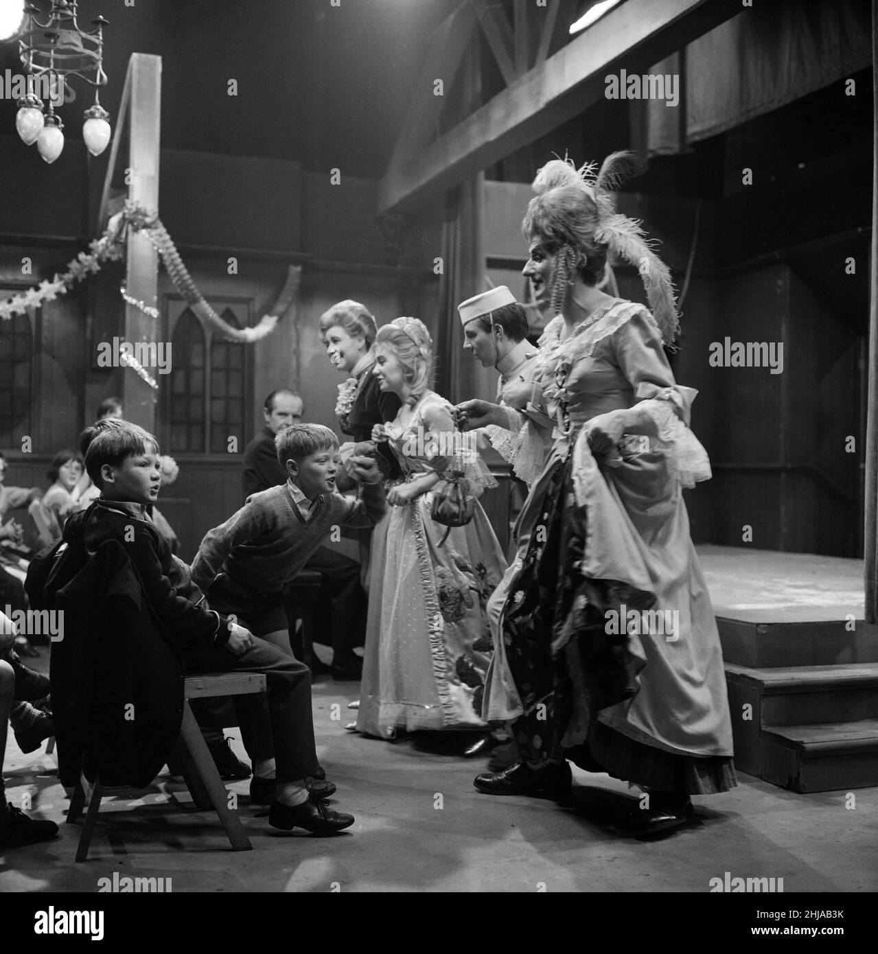When 45 children from Wood Street Mission in Manchester were invited to take part in a 'Coronation Street' pantomime they really had a 'Cinderella' ball. Pat Phoenix (Elsie Tanner), Jennifer Moss (Lucille Hewitt), Philip Lowrie (Dennis Tanner) and Gordon Rollings (Charlie Moffitt) in their panto costumes entertain the children during rehearsals. 18th December 1964. Stock Photo