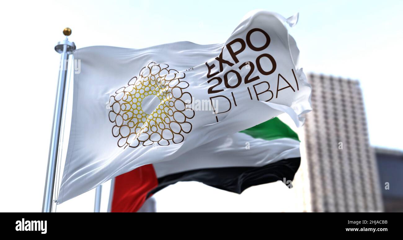 Dubai, UAE, January 2022: the flag of Expo 2020 waving in the wind with the UAE flag blurred in the background. Stock Photo