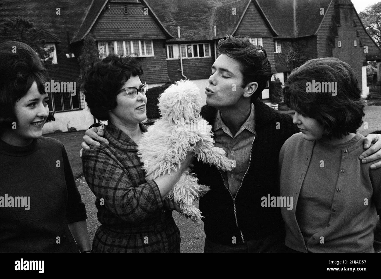 Cliff Richard at his tudor style mansion at Upper Nazeing, Essex. He will live there with his mother and two sisters Jackie 16 and Joan 13. It has six bedrooms, a garage for five cars and is set in eleven acres of ground, the price was ¿30,000. Cliff with his mother Mrs Dorothy Webb (wearing glasses), and sisters Jackie (check skirt) and Joan. 10th November 1963. Stock Photo