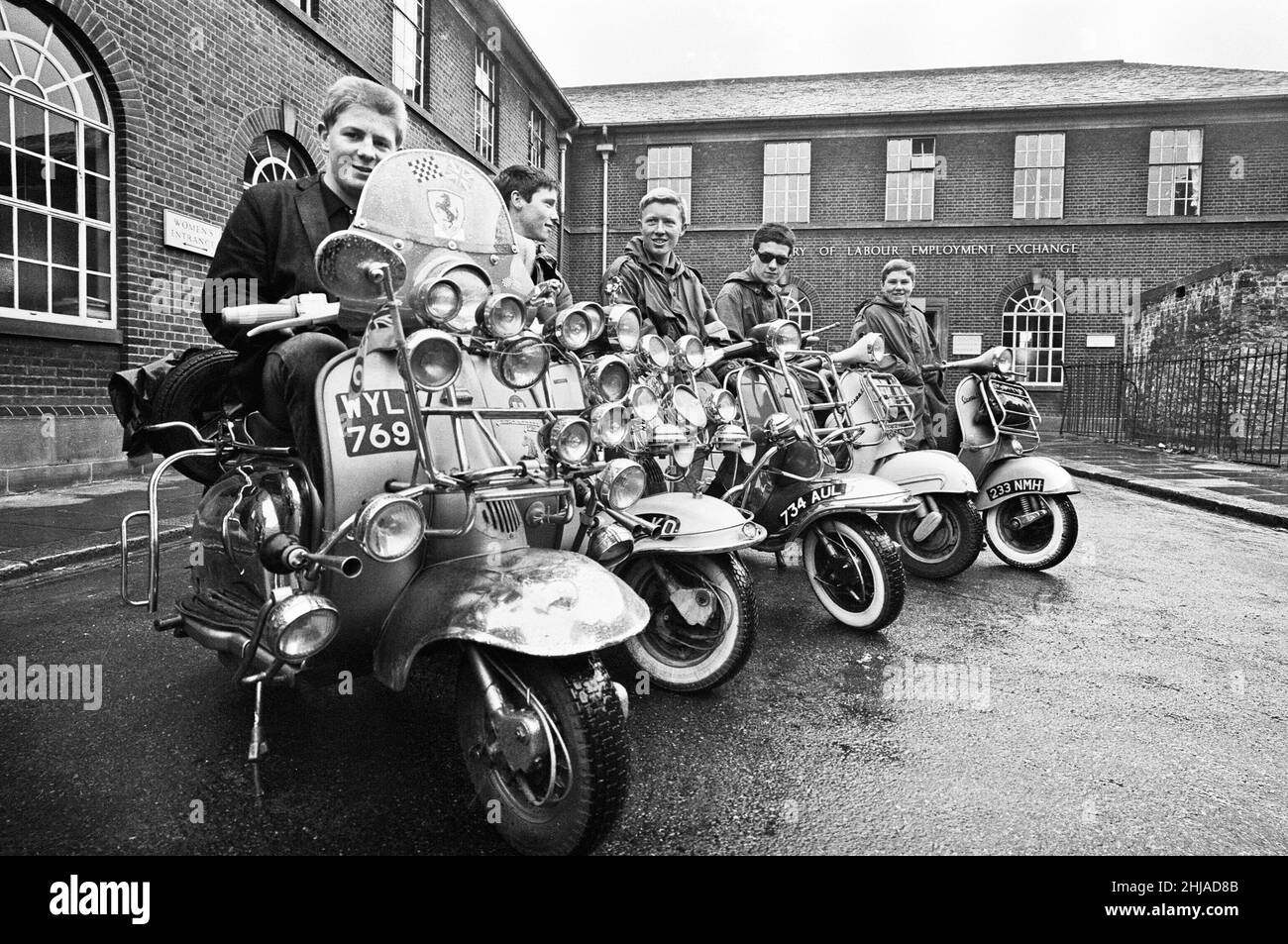 The mods and rockers were two conflicting British youth subcultures of the early to mid-1960s. Media coverage of mods and rockers fighting in 1964 sparked a moral panic about British youths, and the two groups became labelled as folk devils.John Rogers on his scooter with friends in peckham. 6th May 1964. Stock Photo