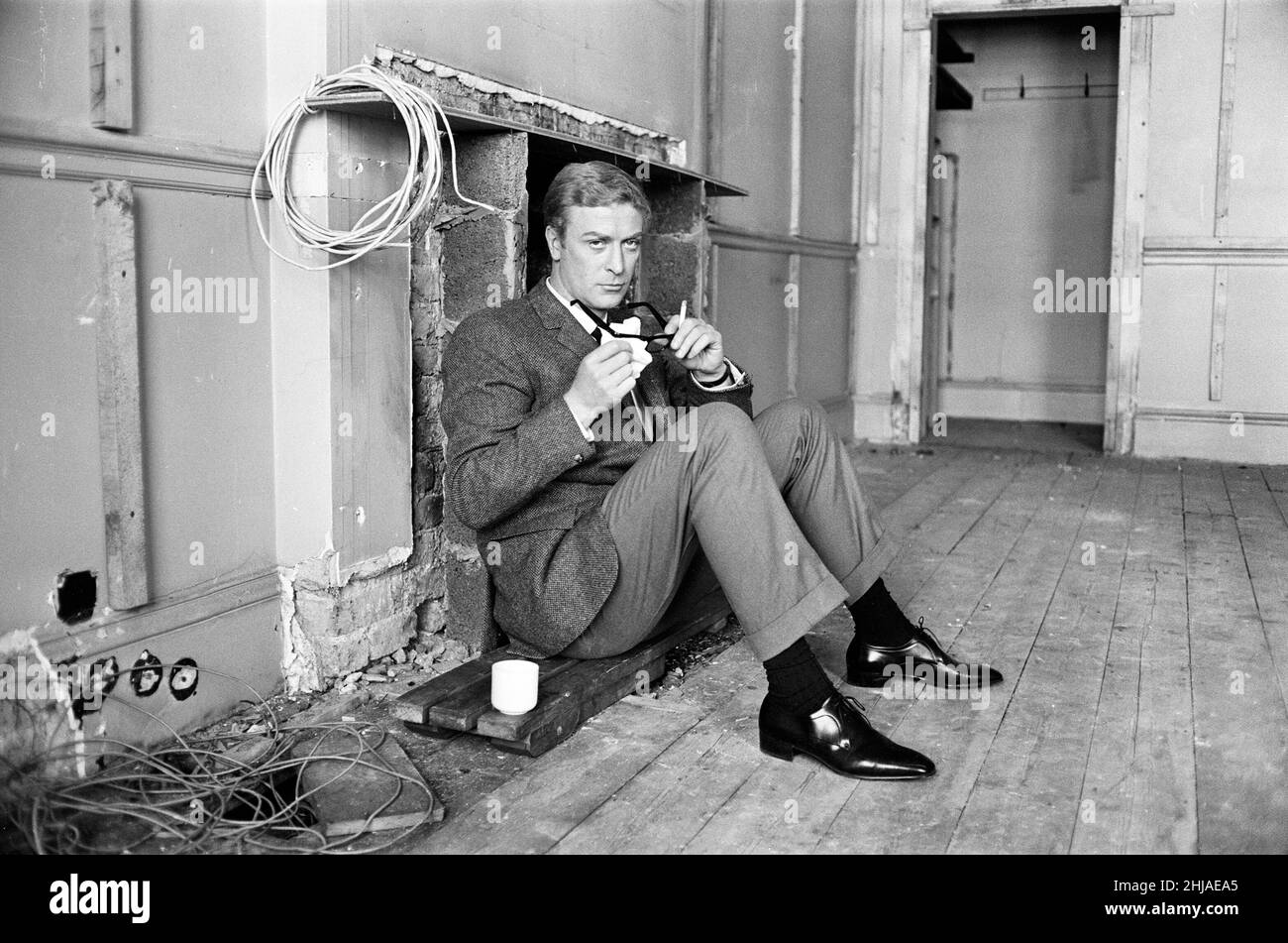 Michael Caine on the set of 'The Ipcress File'. 21st September 1964. Stock Photo