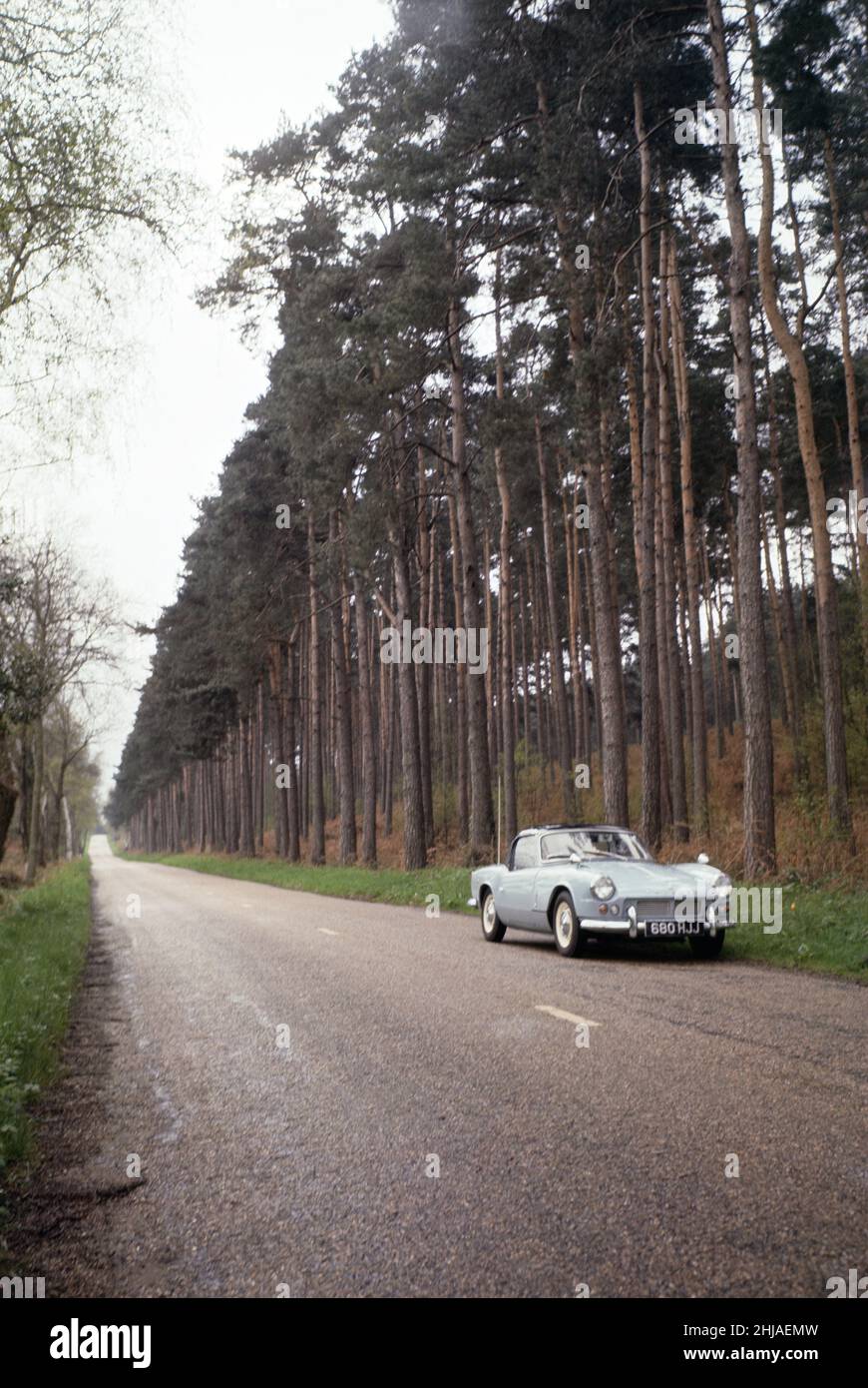 A Triumph Spitfire on a woodland road at Seale in Surrey. April 1964. Stock Photo