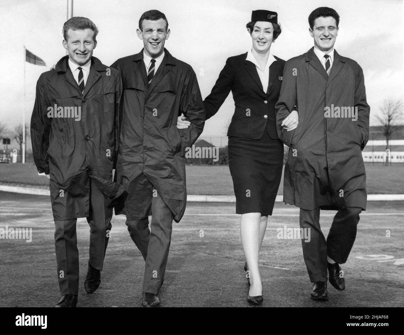 Air Hostess at Renfrew Airport escorts Celtic players Johnstone, Lennox & Gallagher, who are on their way to Spain to play Barcelona in a Fairs Cup match November 1964.  Celtic lost the match 3-1 *** Local Caption *** Lorna McGregor 20 Lonnor McGregor Stock Photo
