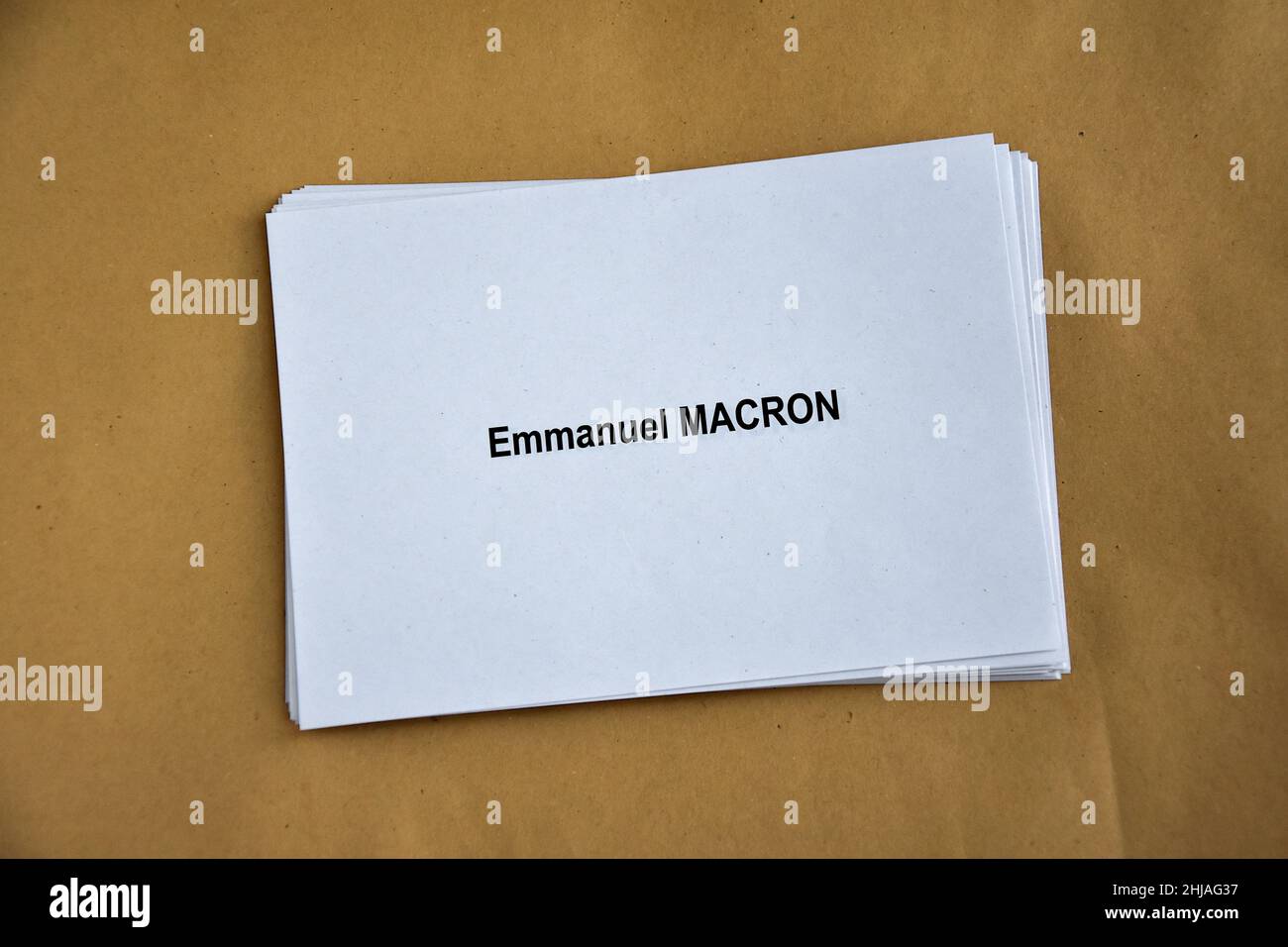 France. 26th Jan, 2022. In this photo illustration, ballot papers of Emmanuel Macron seen piled up on a table. Despite not officially being a candidate for re-election, the President of the French Republic, Emmanuel Macron is leading the polls for the presidential elections of 2022 with 25% of the voting intentions, putting him ahead of Marine Le Pen of the Rassemblement National (RN or National Rally) party, who polled only 17%. The first round of France's Presidential election will take place on April 10, 2022. Credit: SOPA Images Limited/Alamy Live News Stock Photo