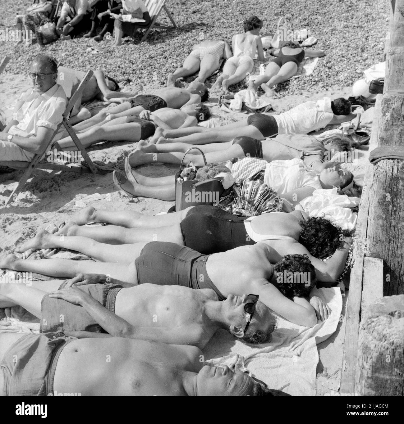 Summer scenes at Bognor Regis, West beach. Sunbathers enjoying the weather. 4th August 1964. Stock Photo