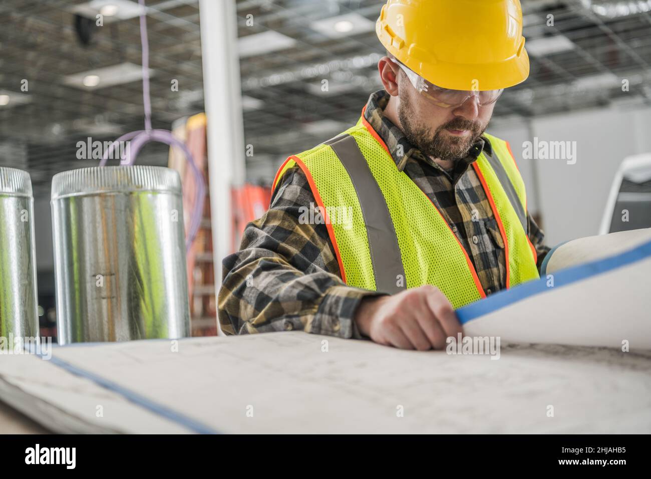HVAC Construction Technician Checking Blueprints. Heating Ventilation and Air Condition Systems