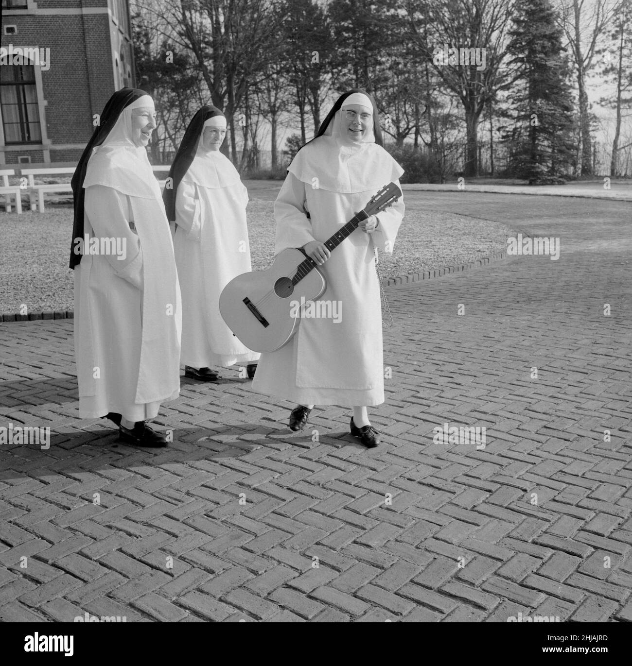 The Singing Nun, born Jeanne-Paule Marie Deckers, she is a nun at the Dominican Fichermont Convent in Fichermont, Belgium.   Pictured with sisters at convent December 1963    A.k.a.  Sister Luc Dominique  Sister Sourine  Jeanine Deckers  Soeur Sourire   Sister Smile Stock Photo
