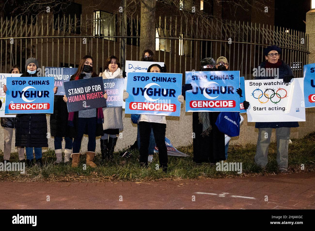 Washington, United States. 27th Jan, 2022. Protesters hold signs that say 'Stop China's Uyghur Genocide', 'Stop watching. Start acting', and 'Stand up for Human Rights' at a protest at the Chinese Embassy against the Uyghur genocide and the Beijing Winter Olympics.The Uyghur Crisis Response Team of the Social Action Committee of Congregation Adas Israel in Washington, DC, sponsored the demonstration. Credit: SOPA Images Limited/Alamy Live News Stock Photo