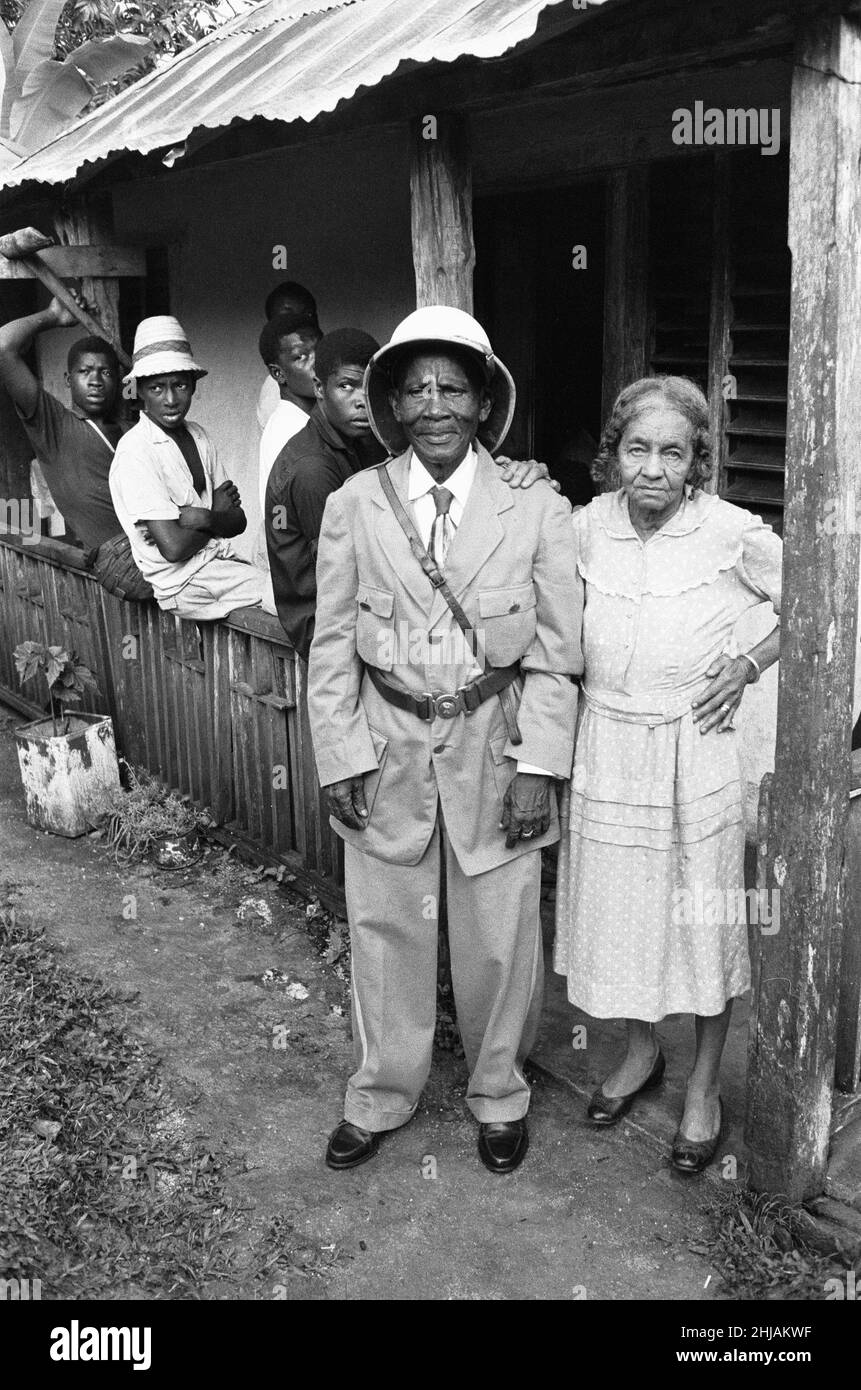Colonel Walter James Robertson, the elderly Jamaican Maroon Chief in full uniform with his wife and fellow maroons outside his house in St Elizabeth. The Maroons are descendants of escaped slaves who established free communities in the mountainous interior of Jamaica during the era of slavery. 15th August 1962 Stock Photo