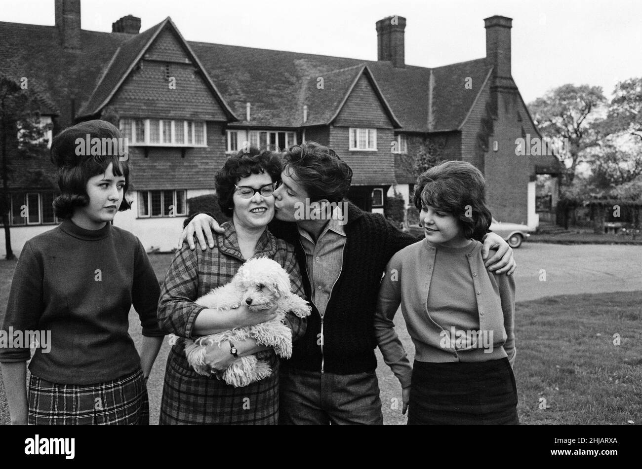 Cliff Richard at his tudor style mansion at Upper Nazeing, Essex. He will live there with his mother and two sisters Jackie 16 and Joan 13. It has six bedrooms, a garage for five cars and is set in eleven acres of ground, the price was ¿30,000. Cliff with his mother Mrs Dorothy Webb (wearing glasses), and sisters Jackie (check skirt) and Joan. 10th November 1963. Stock Photo