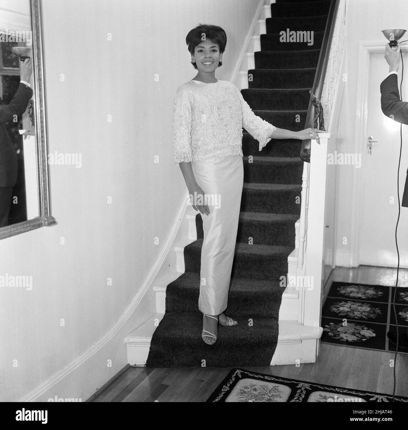 Shirley Bassey, star of the Sunday Night at the Palladium this week. She is wearing a gown of sugar pink silk with a Cleopatra neckline. Her Dior style jacket weights 6 1/2 pounds and is embroidered with pearls, diamante and crystal beads down to the cuffs and hemline. 13th September 1962. Stock Photo