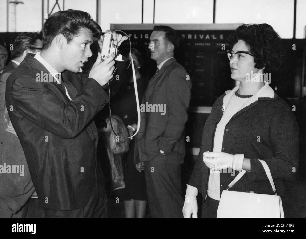 Cliff Richard taking a picture of his Mother at London Airport before leaving for New York. 2nd October 1962. P001726 Stock Photo