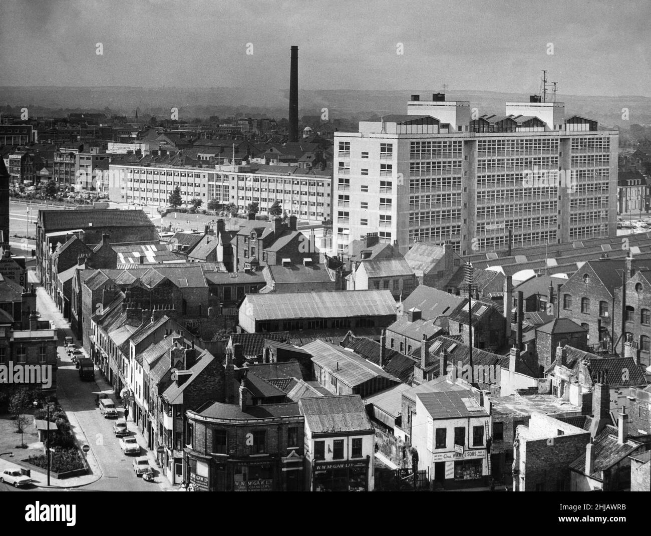 Above the rooftops view. Gleaming white in the afternoon sun is Hull College of Technology and Hull City police headquarters. Through the old buildings in the foreground is a glimpse of Queen's Gardens. 31st August 1963 Stock Photo