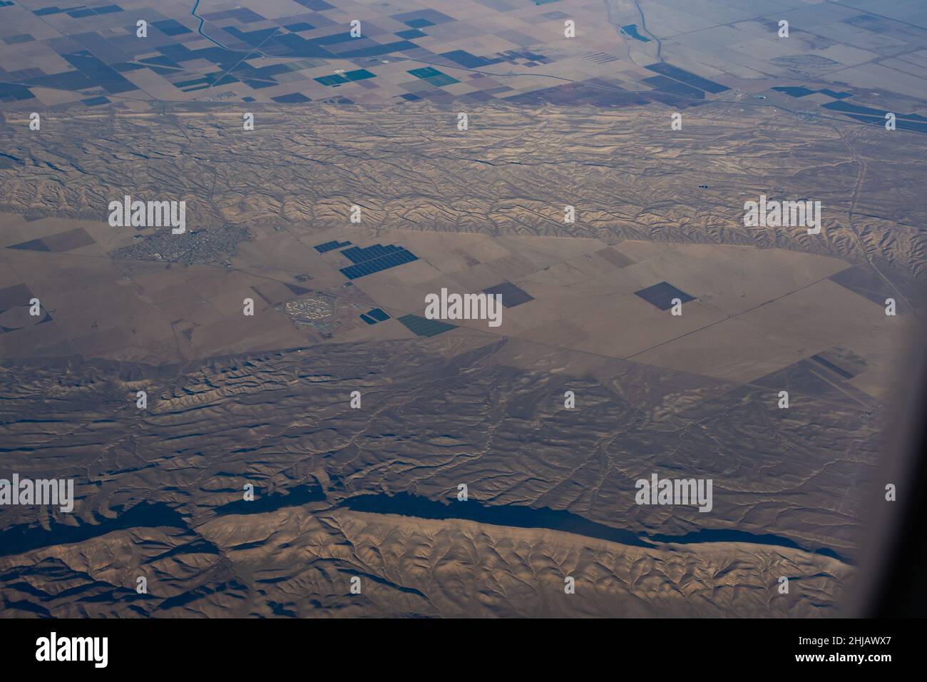 Aerial view of pasture land, solar Farm, small town and Mountains nearby San Andreas Fault Stock Photo