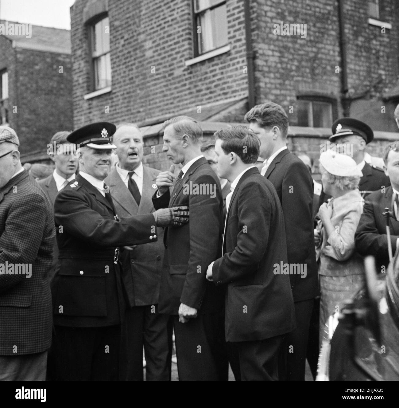 Sir Oswald Mosley visits Manchester to take part in a march organised by his British Union of Fascists supporters, Sunday 29th July 1962. When the eighty marchers gathered, an angry crowd rushed them and Mosley disappeared into a flurry of flying fists and boots and his groups banners were torn to tatters.  Police broke up the fighting mob and rescued 65-year-old Mosley but the march soon turned into a riot causing a mile of terror with fights breaking out every few yards. Many marchers fell out with bleeding faces and torn clothes. The rest were pelted with stones, coins, cabbages, tomatoes a Stock Photo