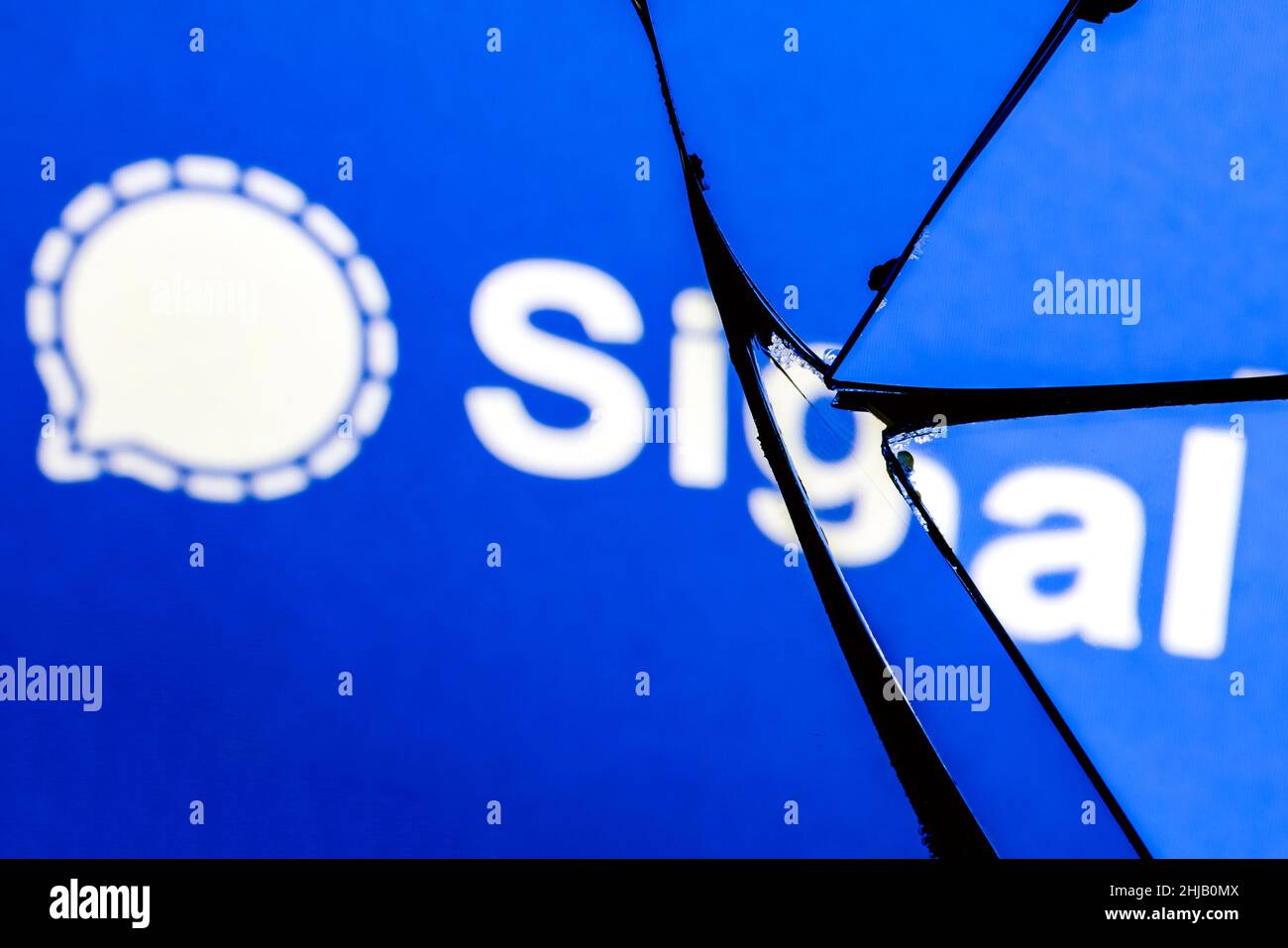 Logo of the Signal encrypted instant messaging service in the reflection of a broken mirror. The concept of problems in the work of Signal. Stock Photo