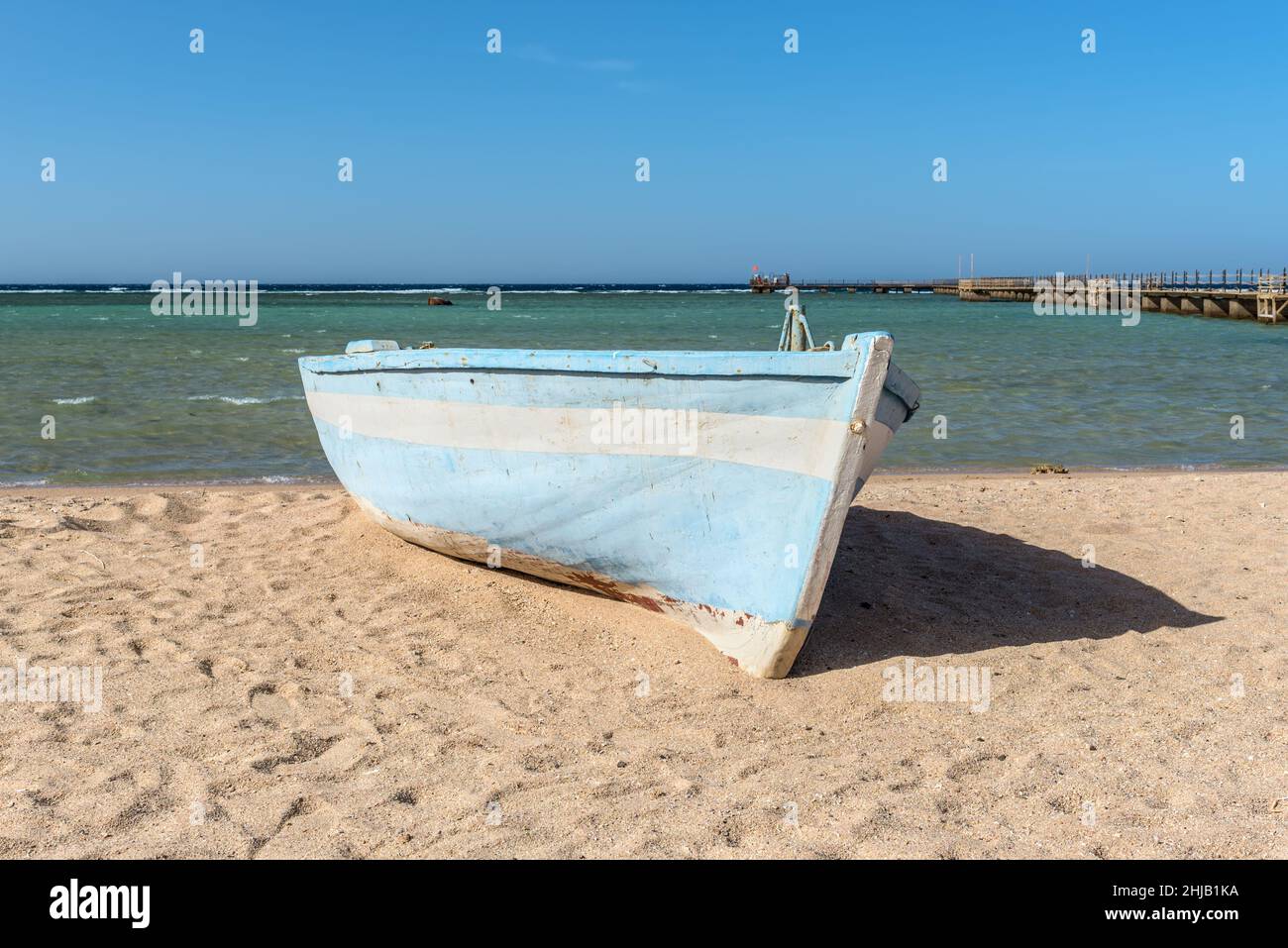 A wooden boat ashore on a beach of the Red Sea, Egypt Stock Photo