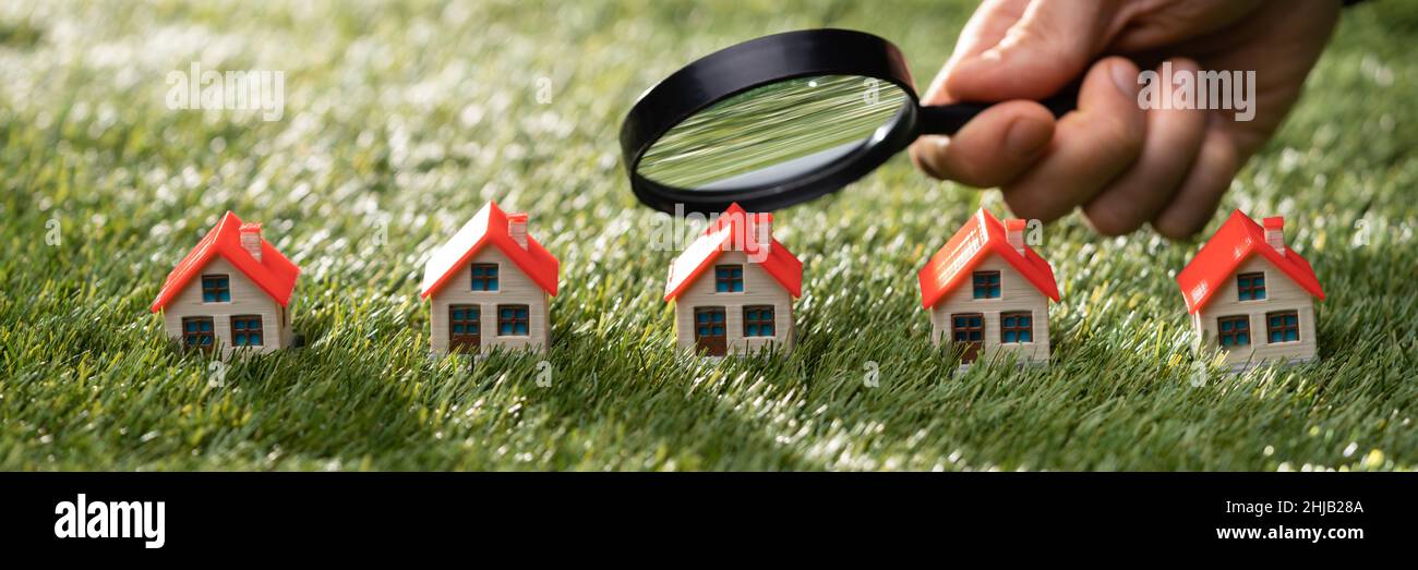 Luxury House And Asset Property Tax Using Magnifying Glass Stock Photo