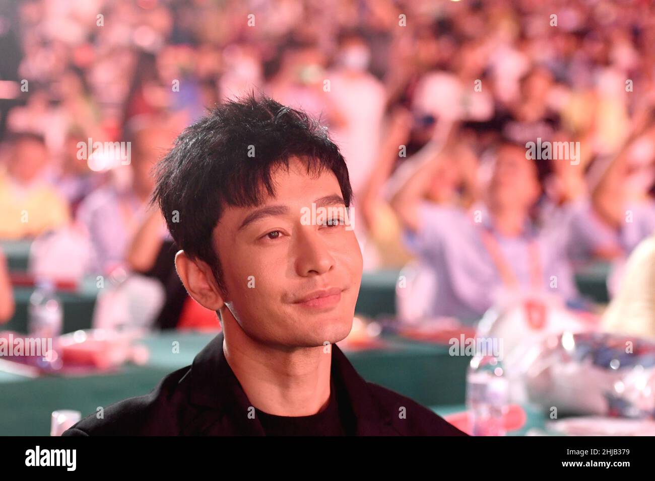 Actor Huang Xiaoming greets hometown residents during the opening ceremony of Qingdao International Beer Festival at the Golden Beach Beer City in the Stock Photo