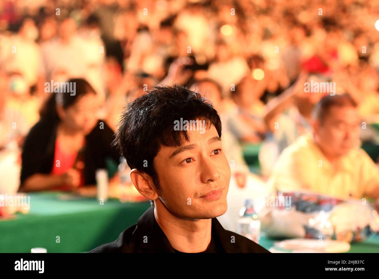 Actor Huang Xiaoming greets hometown residents during the opening ceremony of Qingdao International Beer Festival at the Golden Beach Beer City in the Stock Photo