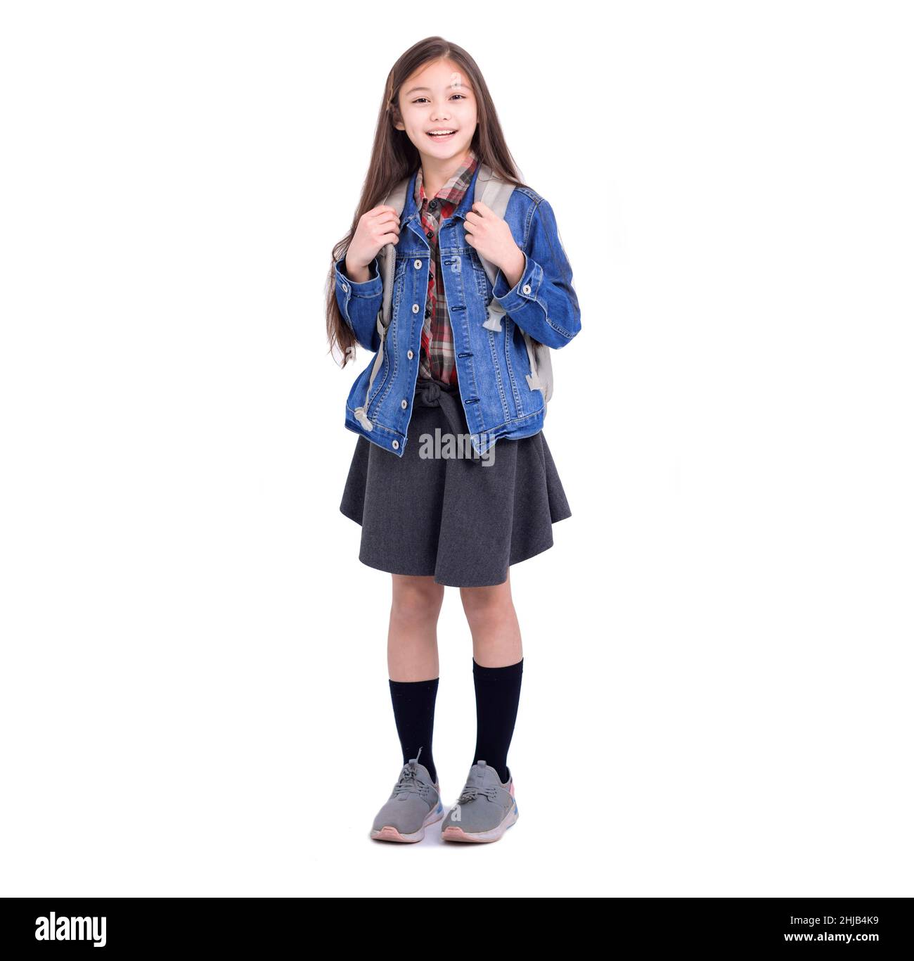 Full length portrait of a smiling girl student with backpack standing ...
