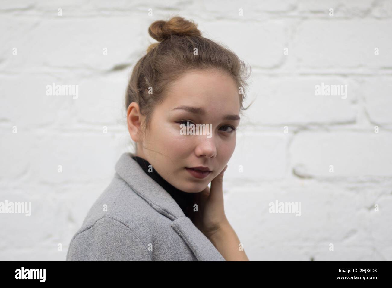 Portrait of young caucasian woman looking at camera with calm look and ...