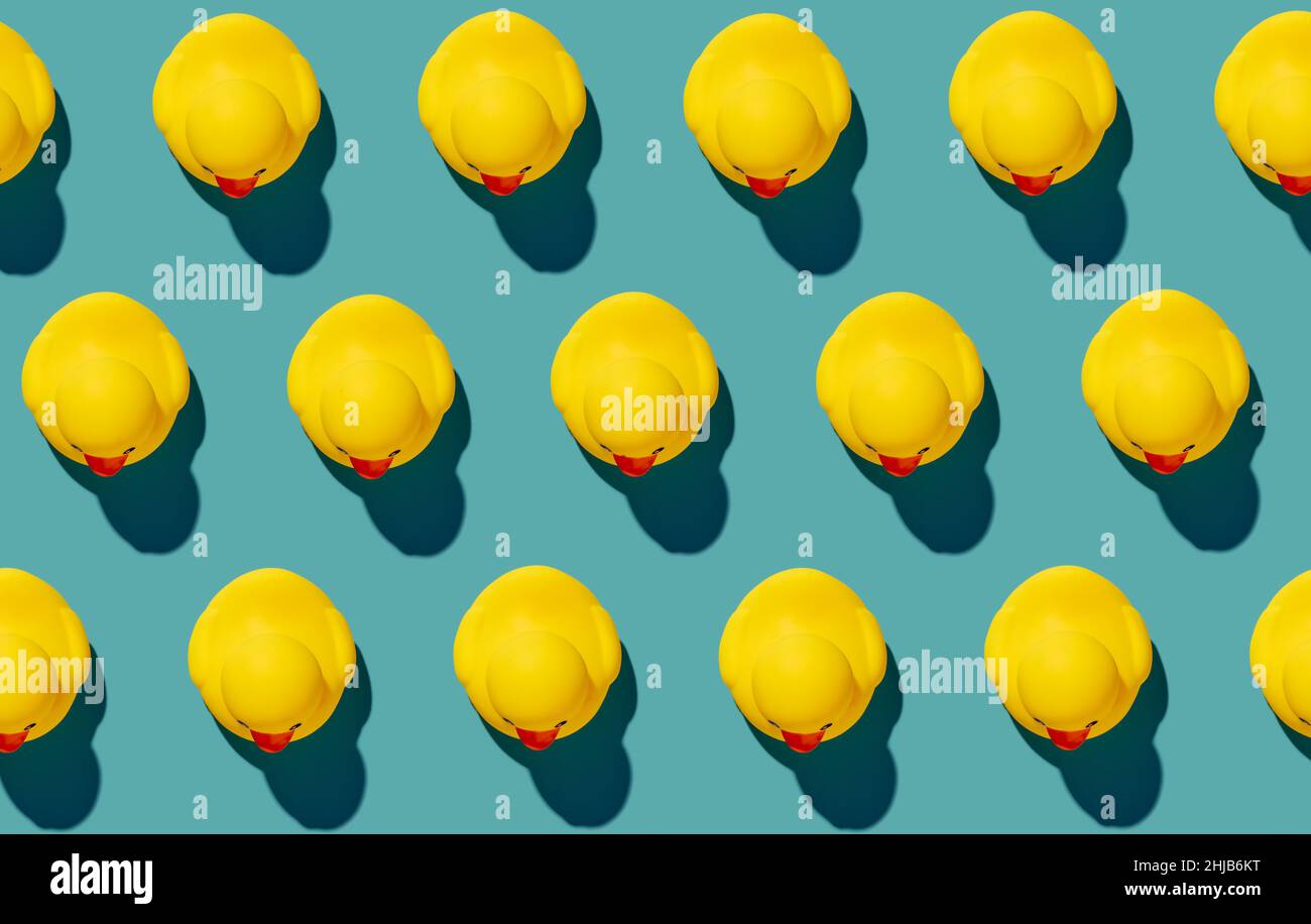 Yellow rubber duck toys pattern on isolated seamless blue background ...