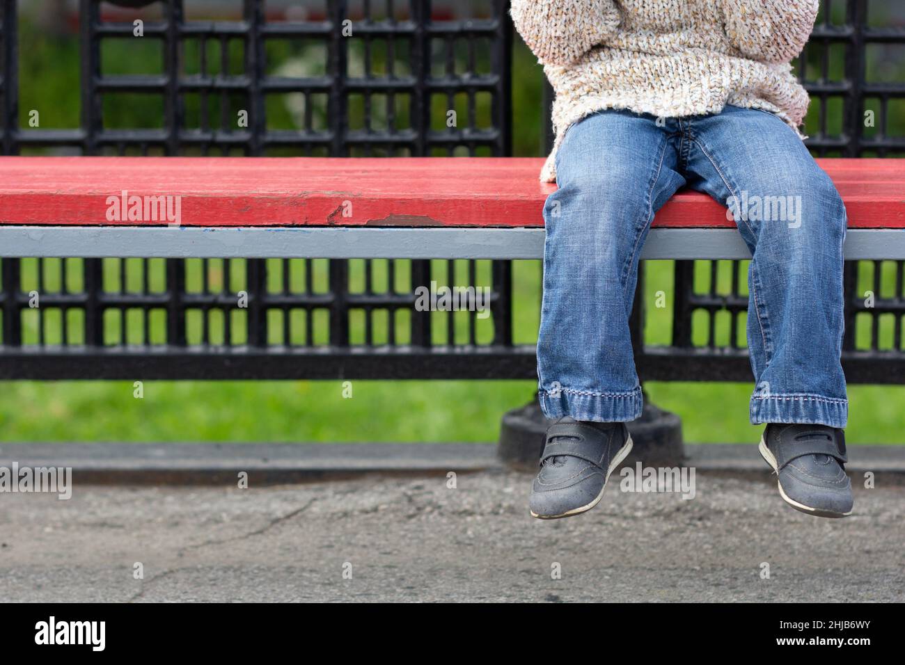 Child legs dangling from bench Stock Photo Alamy