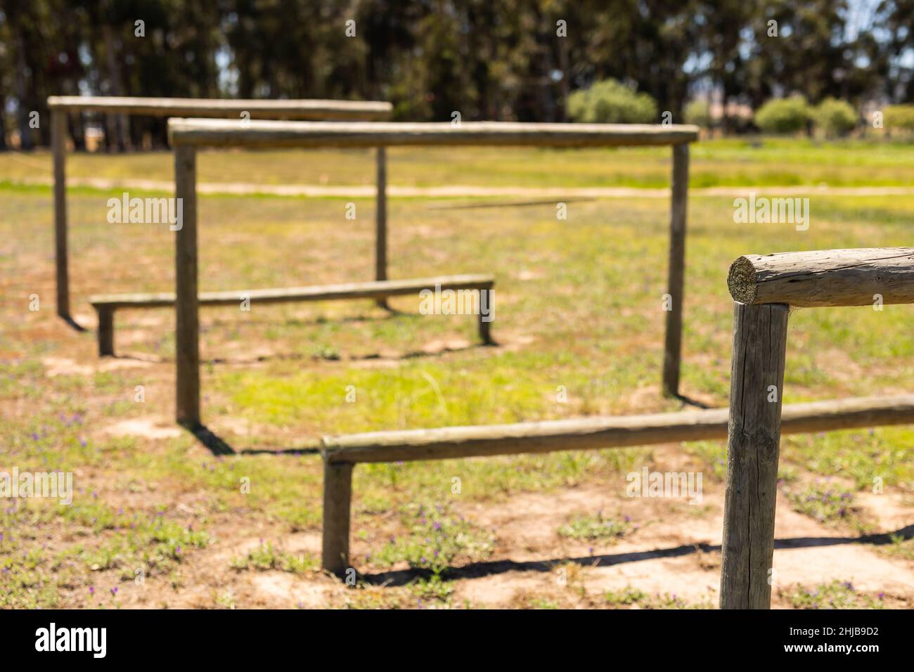 View of wooden hurdles obstacle course on a field at boot camp Stock Photo