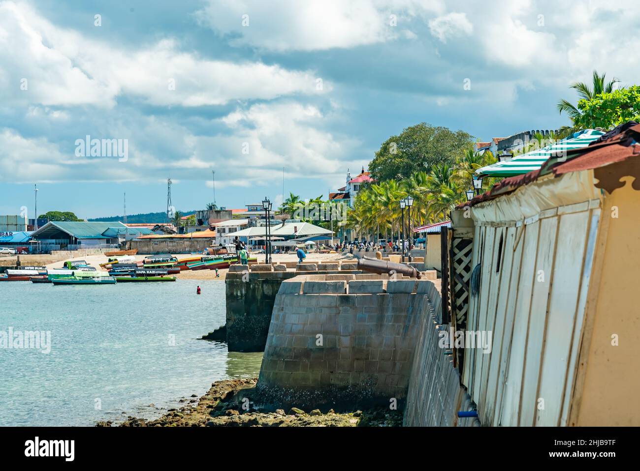 STONE TOWN, ZANZIBAR - DECEMBER 22, 2021: Boats near beach in a port of Stone Town, Zanzibar, Tanzania Stock Photo