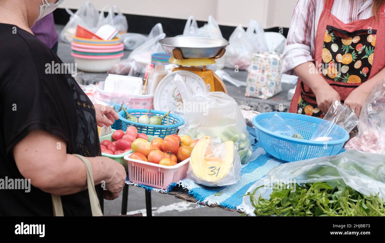 Low Income Economy Money Changing Hands Buyer and Seller Sukhumvit Road Bangkok Thailand Stock Photo