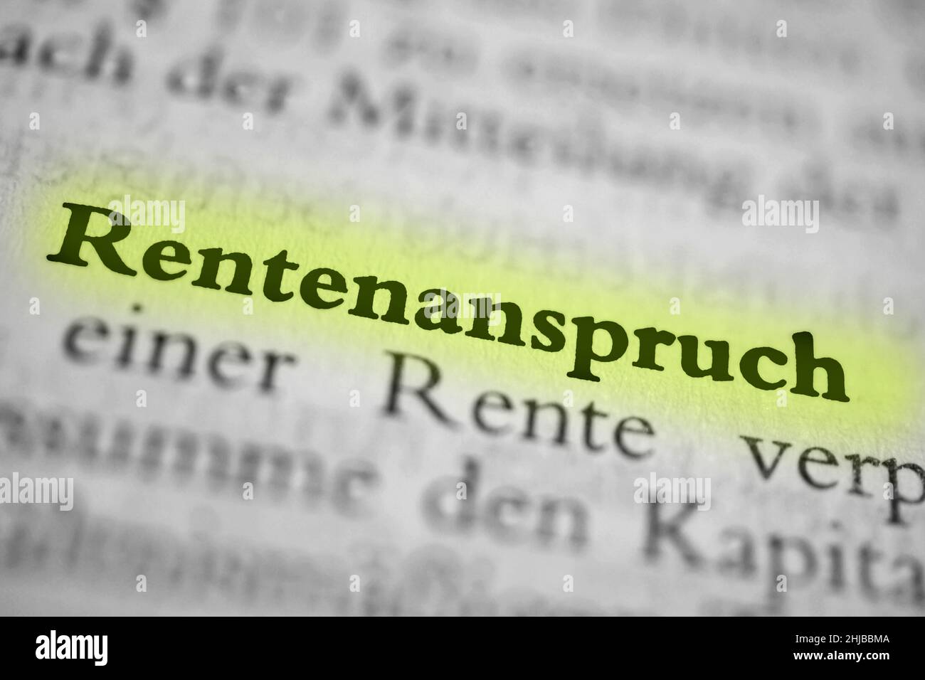 Closeup highlighted German word 'Rentenanspruch' in a newspaper. Translation: pension equalization Stock Photo