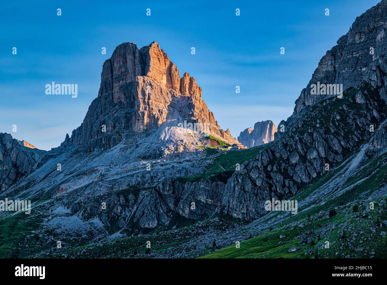 The summit of Mt. Averau and the mountain hut Refugio Averau at the foot of the mountain, seen from Punta di Zonia above Giau Pass, Passo di Giau. Stock Photo