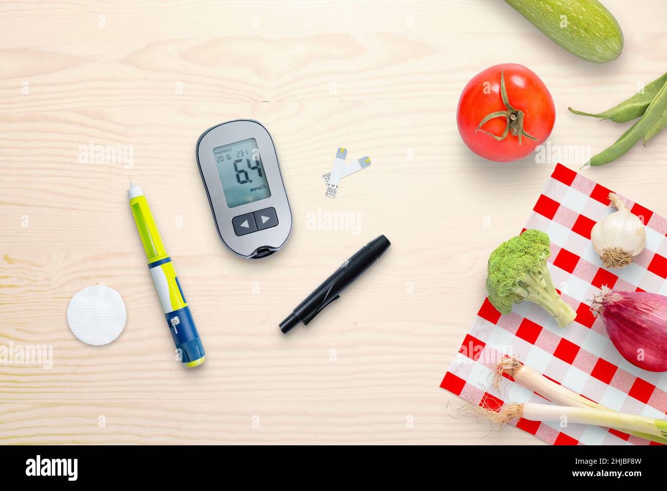 Blood glucose meter and insulin injection on the table beside to