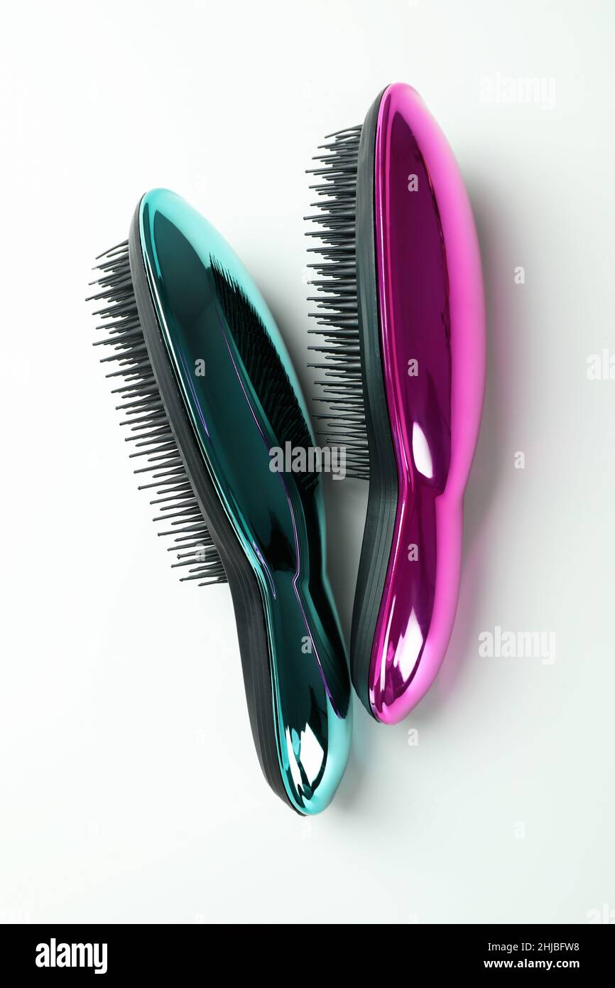Colored plastic hair brushes on white background Stock Photo