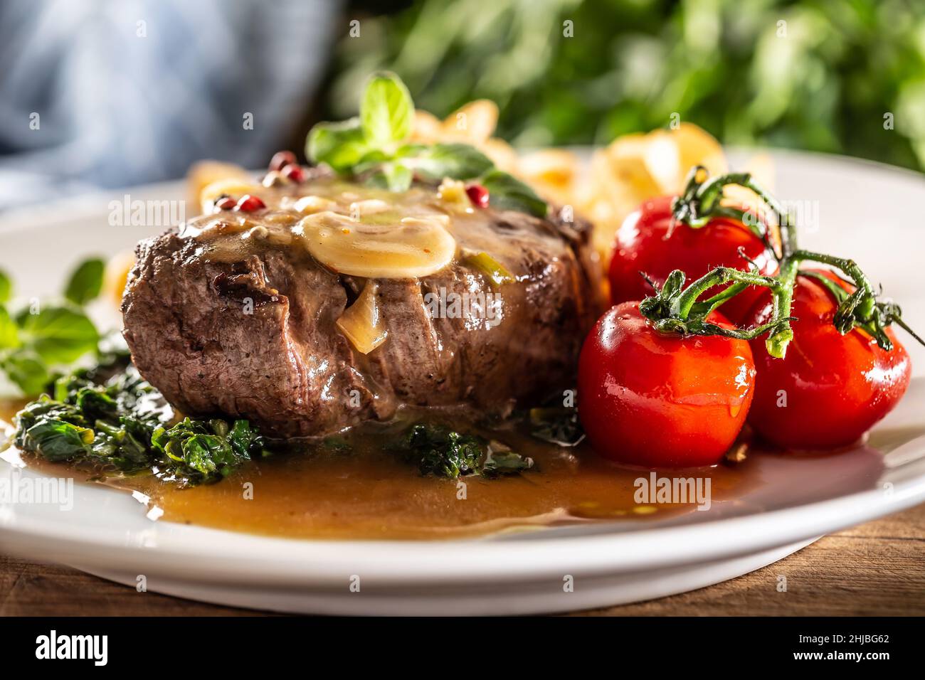 Cooked steak with peppercorn and sauce with healthy veg ready for