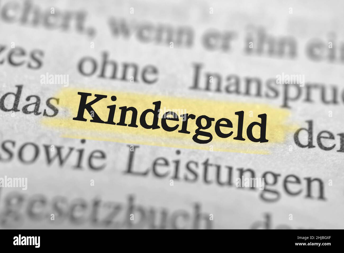 Closeup on the highlighted German word "Kindergeld" in a newspaper
